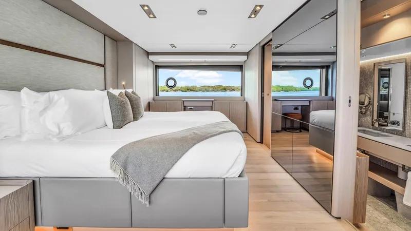 Aurora Yacht Photos Pics Luxurious bedroom interior of 2022 Ferretti Yachts 1000 with modern design and large windows.