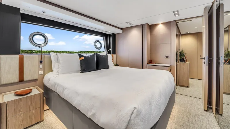 Aurora Yacht Photos Pics Luxurious bedroom interior on 2022 Ferretti Yachts 1000, featuring elegant design and scenic window views.