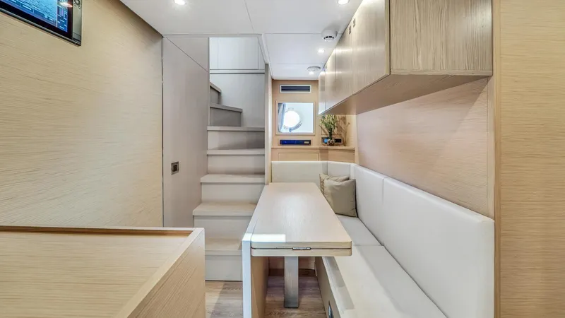 Aurora Yacht Photos Pics Interior of 2022 Ferretti Yachts 1000, featuring modern seating and staircase.
