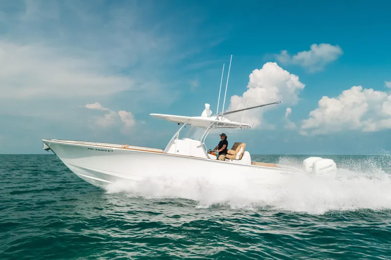  Yacht Photos Pics 2020 Valhalla Boatworks V-33 cruising on open water under a clear blue sky.