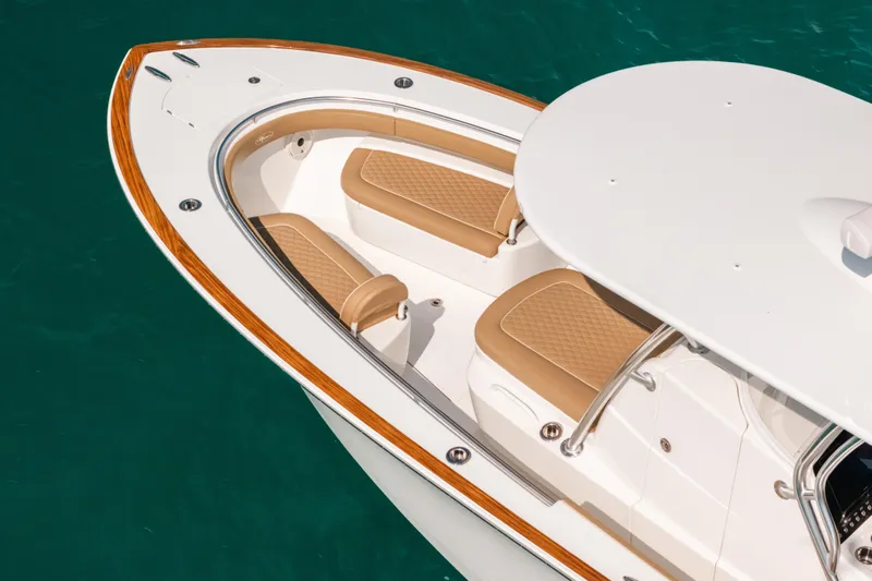  Yacht Photos Pics 2020 Valhalla Boatworks V-33 bow with tan seating, wood trim, on turquoise water.