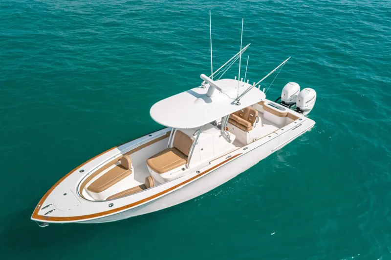  Yacht Photos Pics 2020 Valhalla Boatworks V-33 on clear blue water, showcasing sleek design and twin engines.