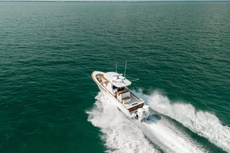  Yacht Photos Pics 2020 Valhalla Boatworks V-33 cruising on open water, creating a dynamic wake.