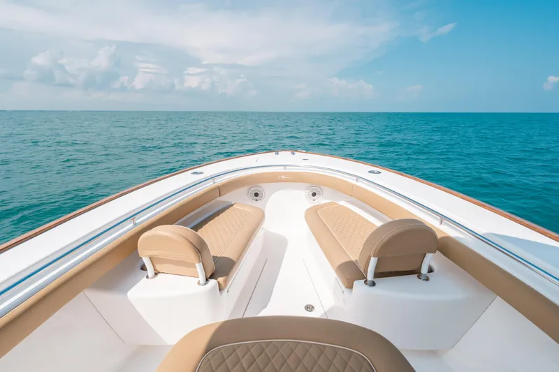  Yacht Photos Pics 2020 Valhalla Boatworks V-33 on open sea, featuring luxurious seating and clear skies.