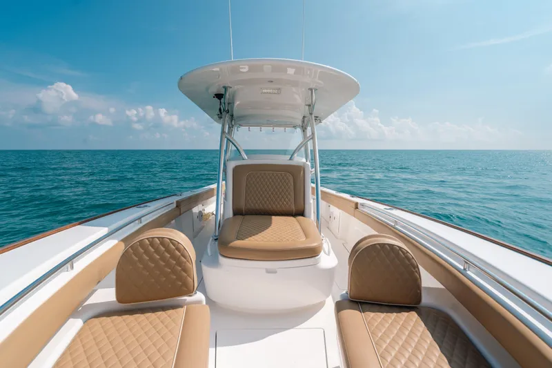  Yacht Photos Pics 2020 Valhalla Boatworks V-33 on open sea, featuring luxurious tan seating.