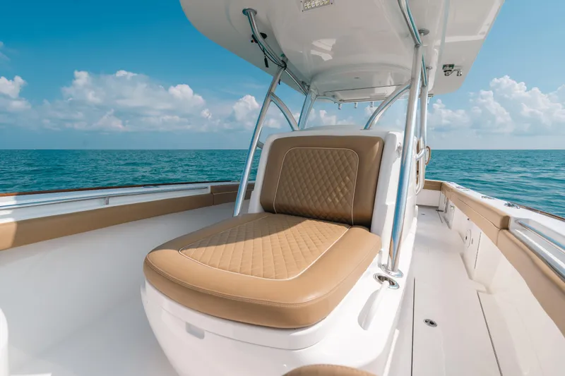  Yacht Photos Pics 2020 Valhalla Boatworks V-33 with tan seating, cruising on open sea under blue sky.