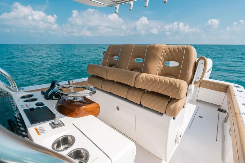  Yacht Photos Pics 2020 Valhalla Boatworks V-33 helm with tan seating, ocean view, and clear sky.