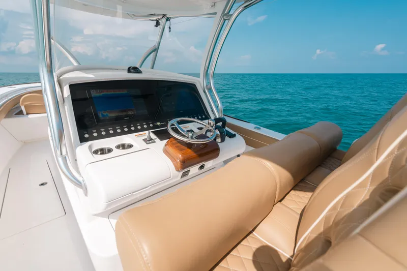  Yacht Photos Pics 2020 Valhalla Boatworks V-33 helm with tan seating, open sea view.