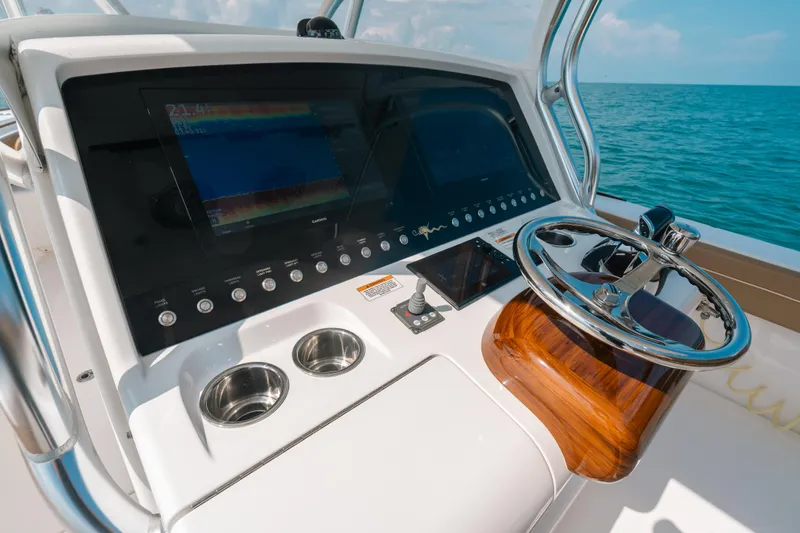  Yacht Photos Pics Control panel of 2020 Valhalla Boatworks V-33 with steering wheel and navigation screens.