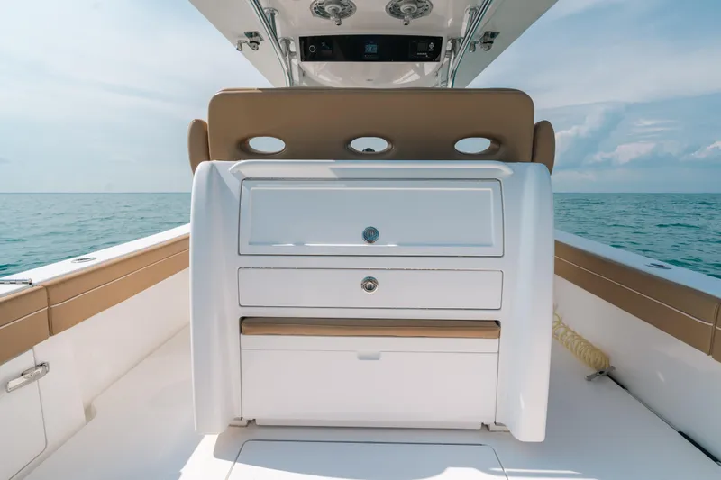  Yacht Photos Pics 2020 Valhalla Boatworks V-33 interior with ocean view, featuring sleek white and tan design.