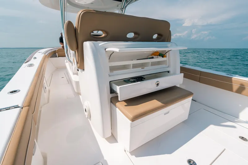  Yacht Photos Pics 2020 Valhalla Boatworks V-33 interior with storage drawers, tan seating, and ocean view.