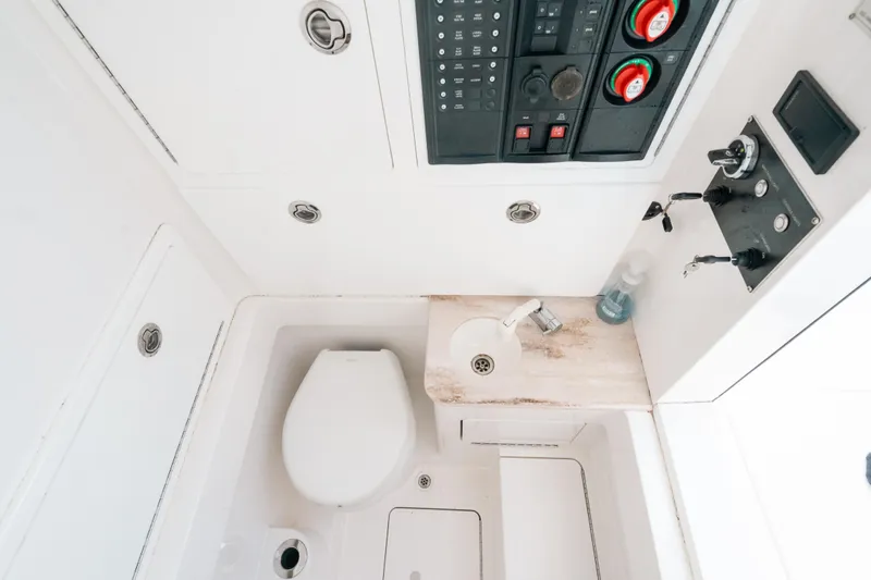  Yacht Photos Pics 2020 Valhalla Boatworks V-33 interior with toilet, sink, and control panel.