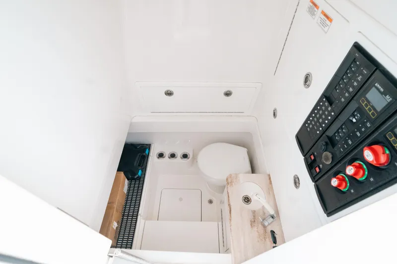  Yacht Photos Pics 2020 Valhalla Boatworks V-33 interior with control panel and compact toilet.