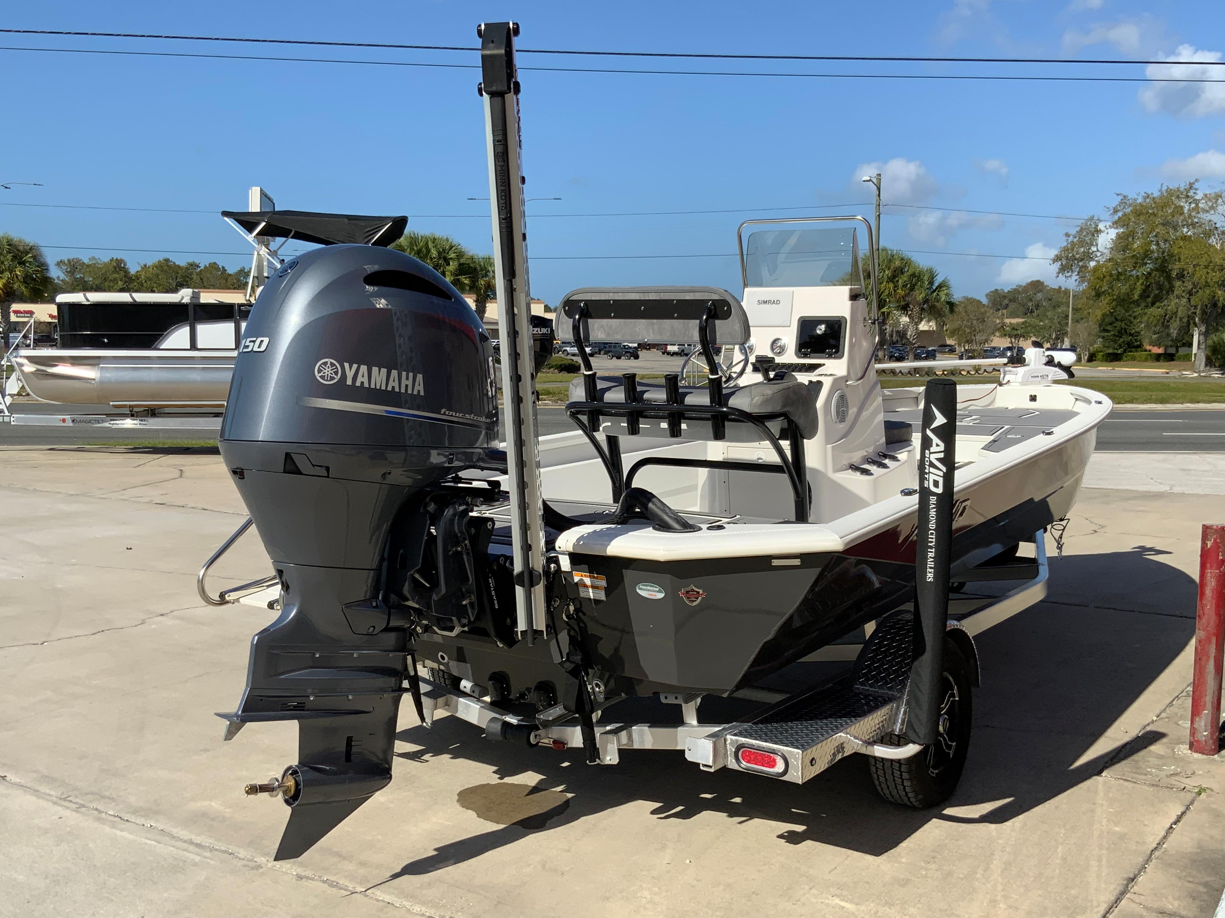 2023 Avid 21 Mag boat with Yamaha 150 outboard motor, parked on a trailer.