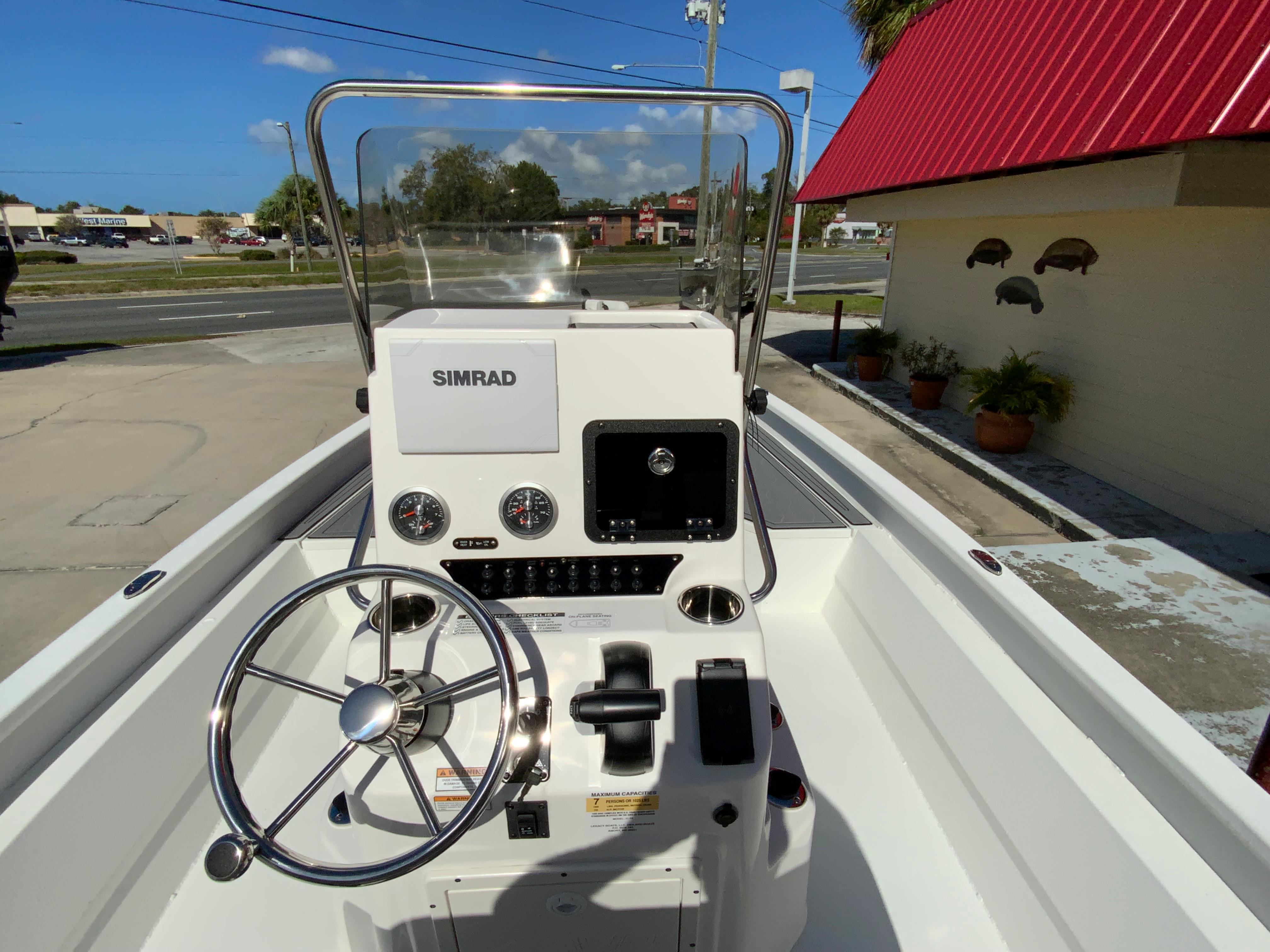 2023 Avid 21 Mag boat console with Simrad electronics and steering wheel.