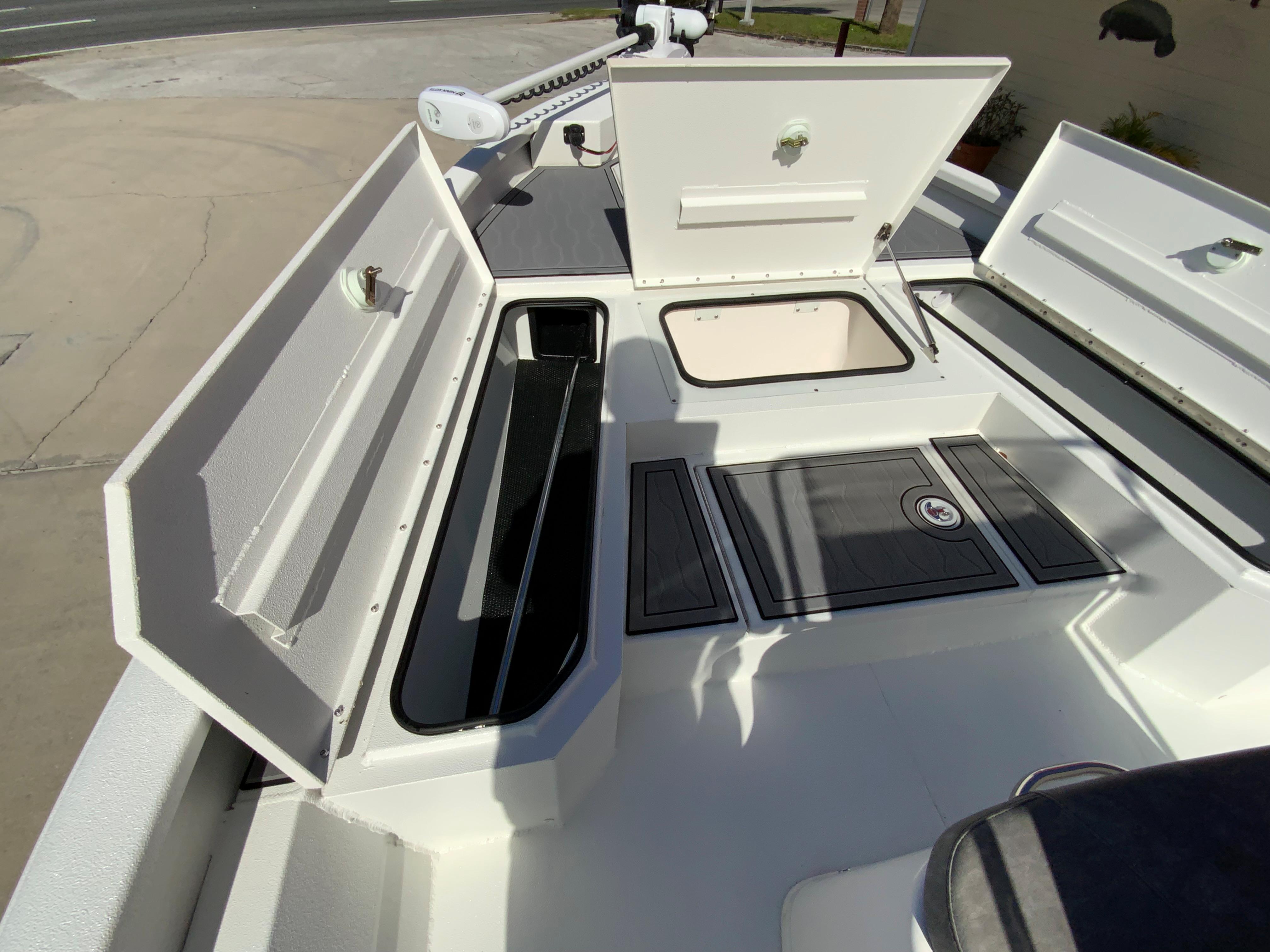 2023 Avid 21 Mag boat with open storage compartments and deck view.
