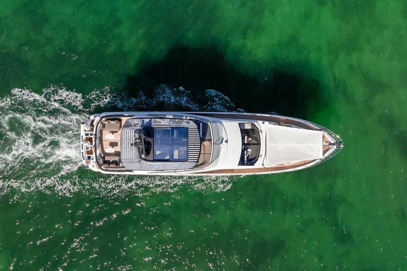  Yacht Photos Pics Top view of 2021 Azimut Fly 78 yacht cruising on vibrant green water.