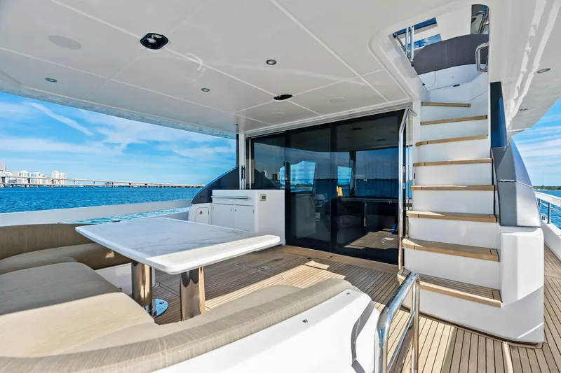  Yacht Photos Pics Luxurious 2021 Azimut Fly 78 yacht deck with seating, table, and ocean view.