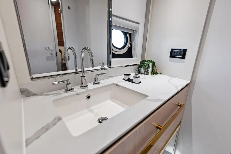  Yacht Photos Pics Luxurious bathroom sink in 2021 Azimut Fly 78 yacht, featuring modern fixtures and elegant design.