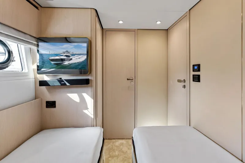  Yacht Photos Pics Interior of 2021 Azimut Fly 78 yacht cabin with twin beds and wall-mounted TV.