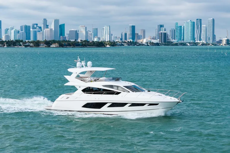  Yacht Photos Pics 2016 Sunseeker Manhattan 65 yacht cruising with city skyline backdrop.