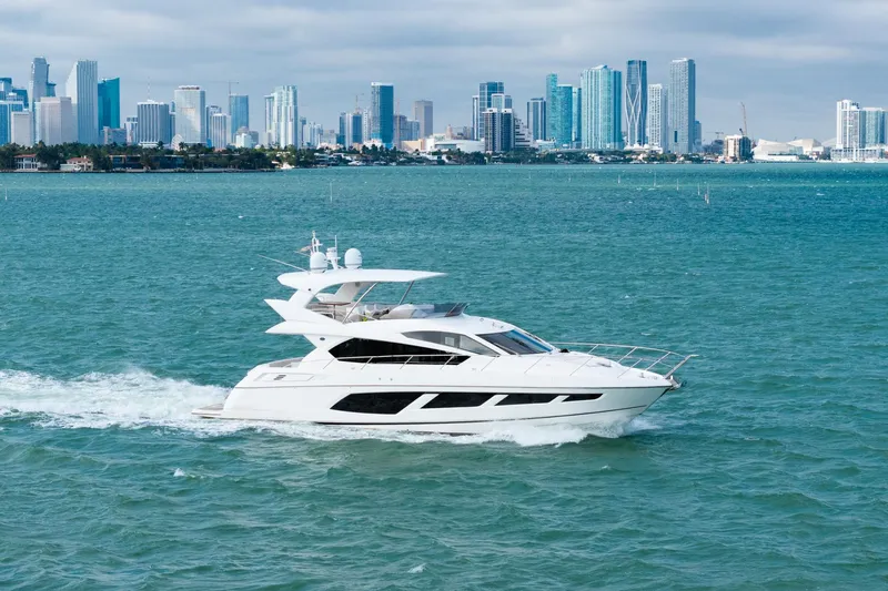  Yacht Photos Pics 2016 Sunseeker Manhattan 65 yacht cruising near a city skyline.