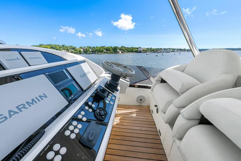  Yacht Photos Pics 2016 Sunseeker Manhattan 65 yacht helm with Garmin navigation, overlooking serene waters.