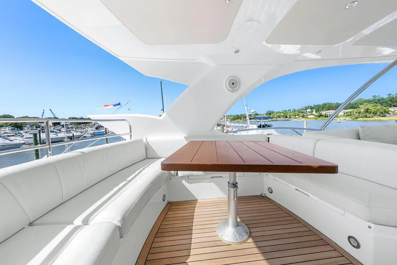  Yacht Photos Pics Luxurious Sunseeker Manhattan 65 yacht interior with elegant seating and wooden table, 2016 model.