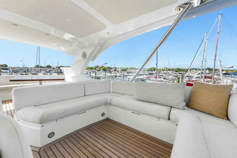  Yacht Photos Pics Luxurious Sunseeker Manhattan 65 yacht interior, 2016 model, featuring elegant white seating and marina view.