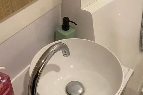  Yacht Photos Pics Modern bathroom sink with sleek faucet on Aquila 42, 2023 model.