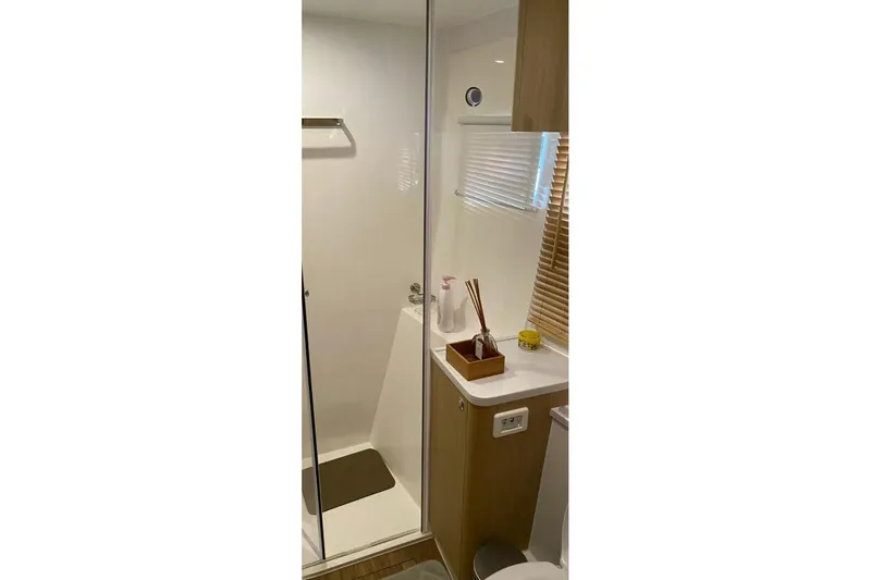  Yacht Photos Pics Modern bathroom interior in 2023 Aquila 42 yacht, featuring shower and wooden accents.