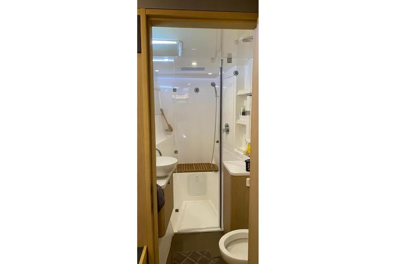  Yacht Photos Pics Modern bathroom in 2023 Aquila 42 yacht with shower, sink, and toilet.