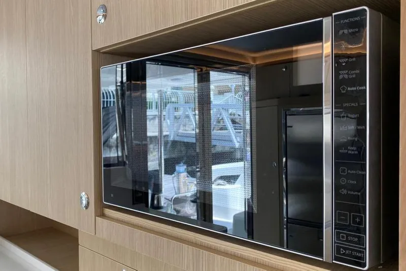  Yacht Photos Pics Modern microwave in 2023 Aquila 42 yacht kitchen, featuring sleek design and digital controls.