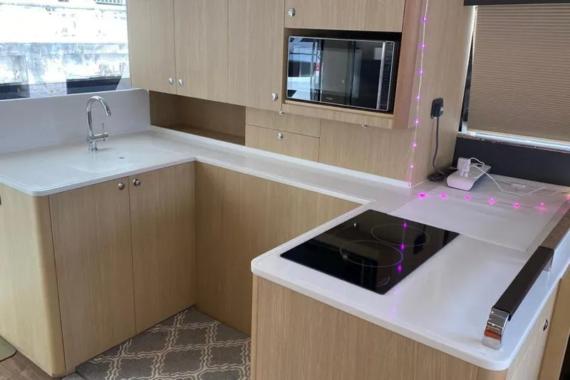  Yacht Photos Pics Modern kitchen in 2023 Aquila 42 yacht with sleek countertops and built-in appliances.