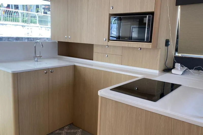  Yacht Photos Pics Modern kitchen interior in 2023 Aquila 42 yacht with sleek cabinetry and appliances.