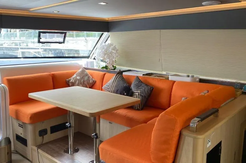  Yacht Photos Pics Luxurious 2023 Aquila 42 yacht interior with vibrant orange seating and modern decor.