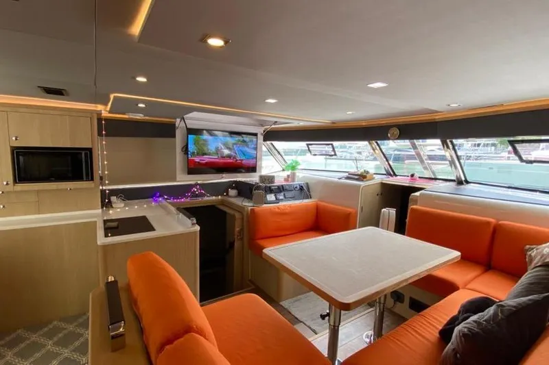  Yacht Photos Pics Luxurious interior of 2023 Aquila 42 yacht with orange seating and modern amenities.