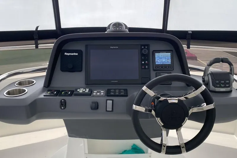  Yacht Photos Pics Cockpit of 2023 Aquila 42 yacht featuring Raymarine navigation system and modern steering wheel.