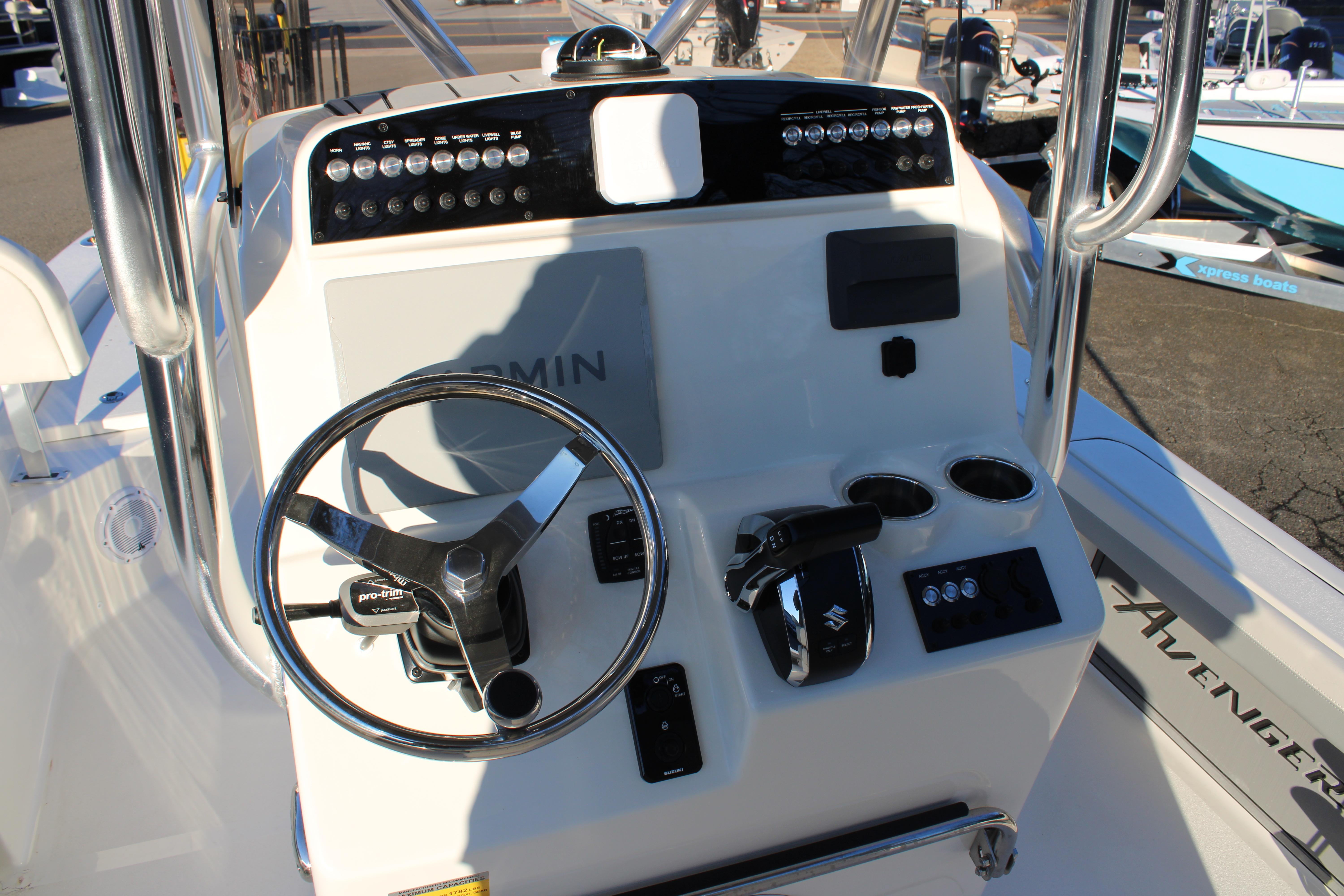Avenger AV26 2025 boat dashboard with steering wheel and controls.