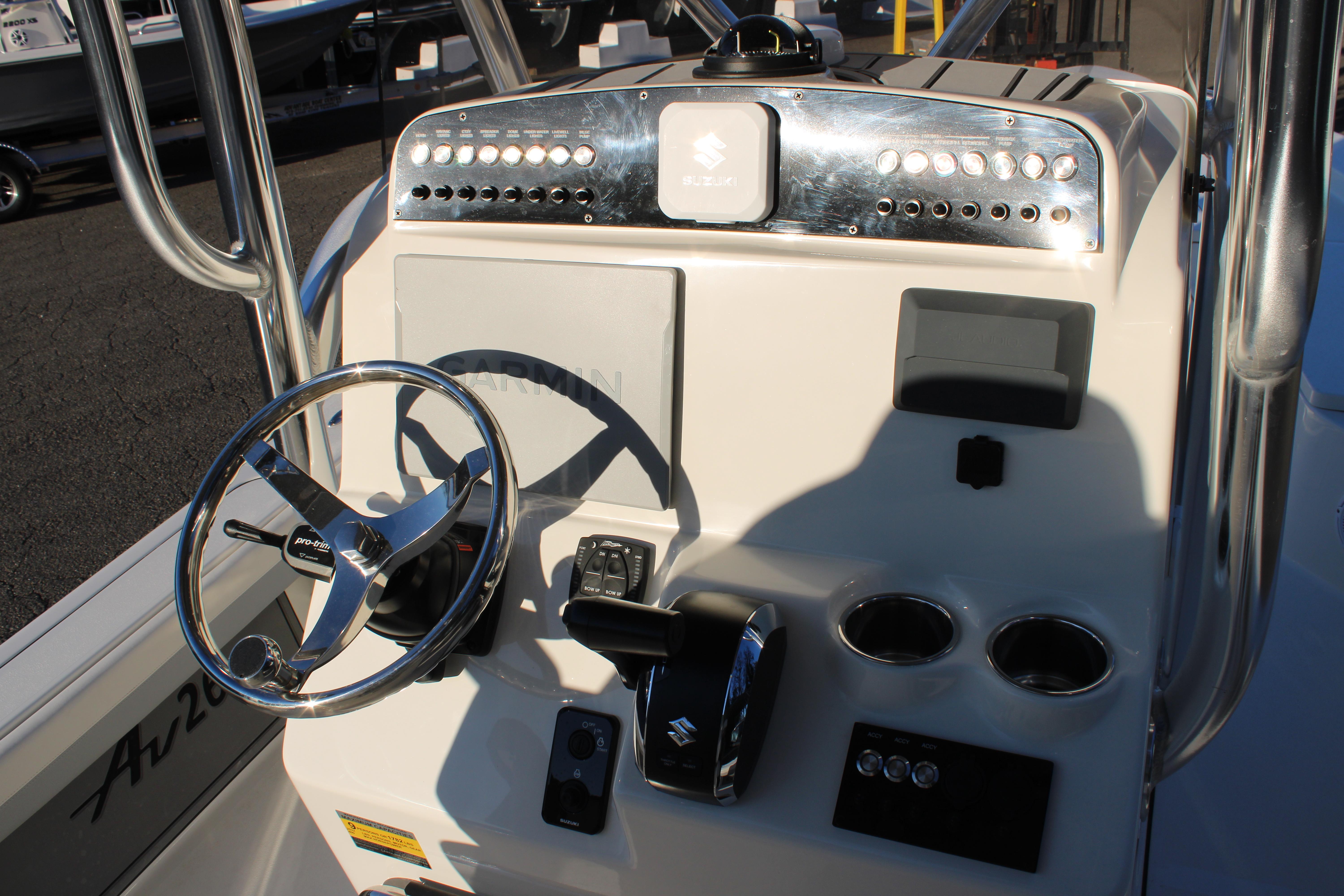 Control panel of 2025 Avenger AV26 boat with steering wheel and gauges.
