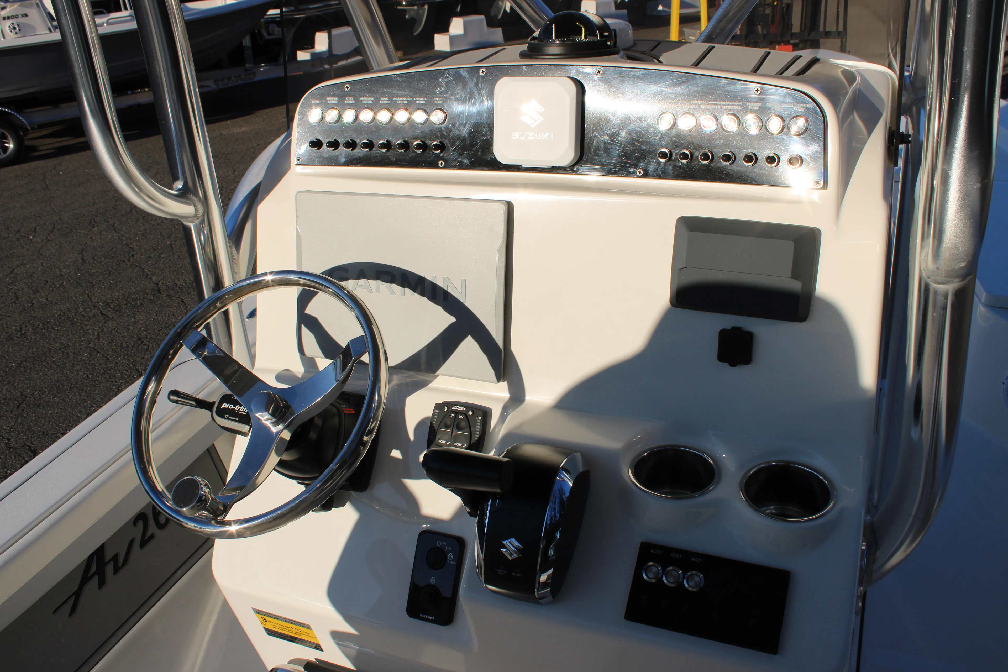 Control panel of 2025 Avenger AV26 boat with steering wheel and gauges.