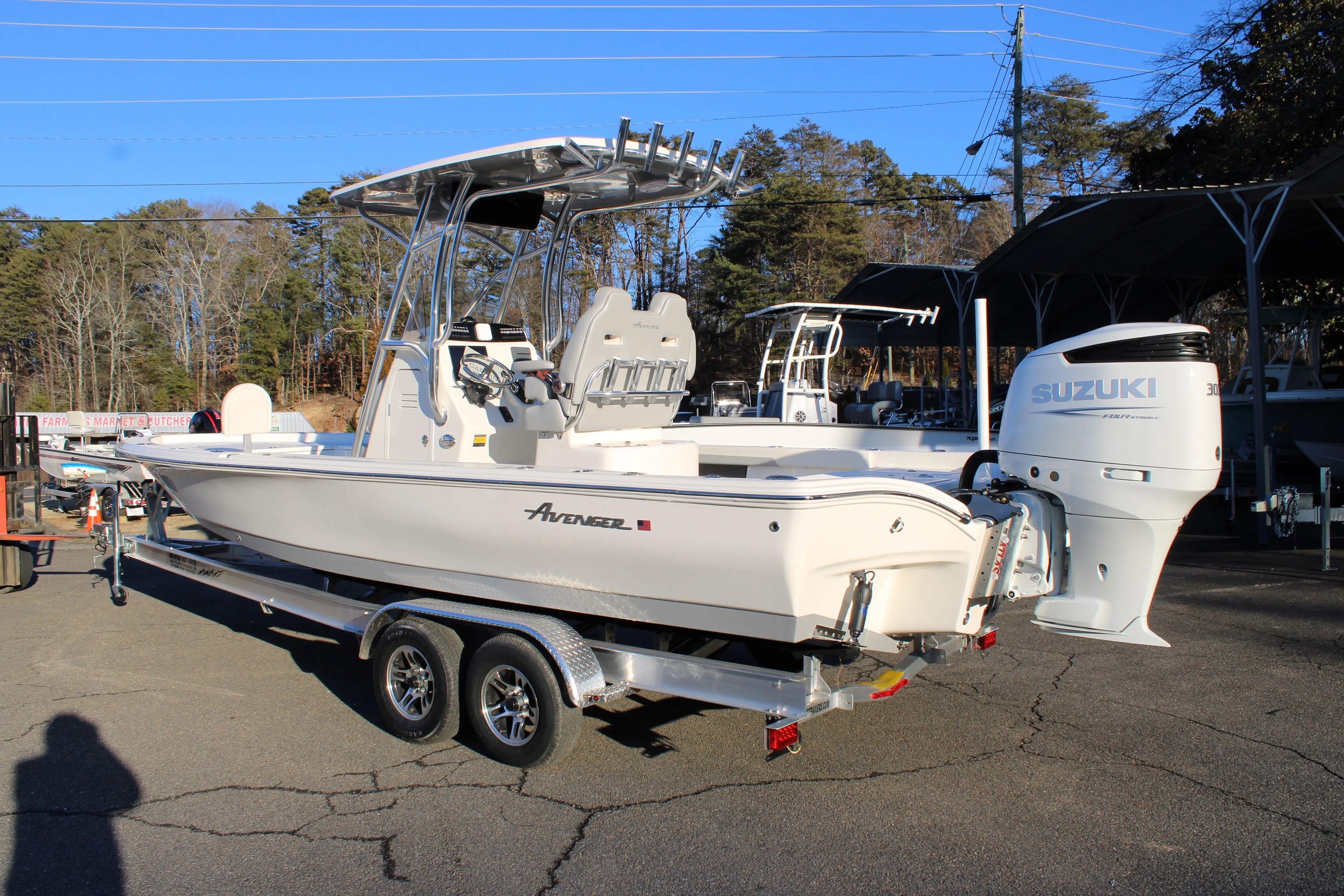 2025 Avenger AV26 boat on trailer with Suzuki outboard motor in a parking lot.