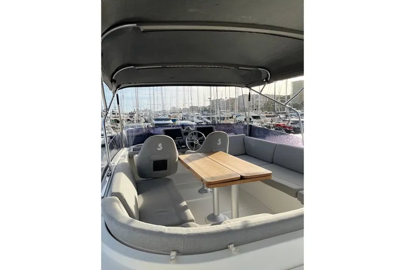 Odoo Id - 2.110 Yacht Photos Pics 2021 Beneteau Swift Trawler 50 interior with seating and table, docked at marina.
