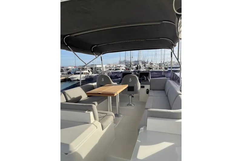 Odoo Id - 2.110 Yacht Photos Pics 2021 Beneteau Swift Trawler 50 flybridge with seating and table, docked at marina.