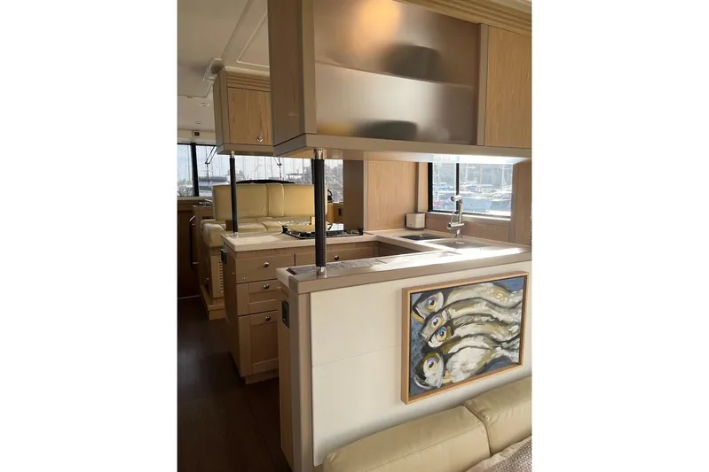 Odoo Id - 2.110 Yacht Photos Pics Interior of 2021 Beneteau Swift Trawler 50 with modern kitchen and fish artwork.