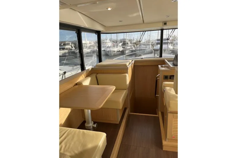 Odoo Id - 2.110 Yacht Photos Pics Interior of 2021 Beneteau Swift Trawler 50 with seating and table, marina view.