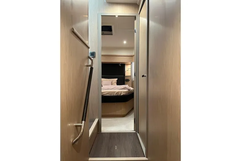 Odoo Id - 2.110 Yacht Photos Pics Interior hallway of 2021 Beneteau Swift Trawler 50, leading to a cozy bedroom.
