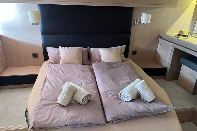 Odoo Id - 2.110 Yacht Photos Pics Luxurious bedroom interior of 2021 Beneteau Swift Trawler 50 with neatly arranged bedding.