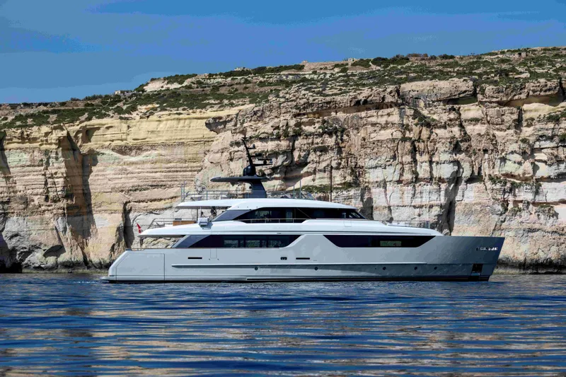 Unique S Yacht Photos Pics 2024 Sanlorenzo SD118 yacht cruising near rocky cliffs.