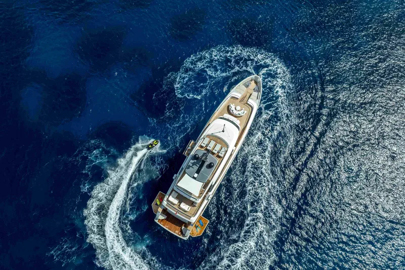 Unique S Yacht Photos Pics Aerial view of 2024 Sanlorenzo SD118 yacht cruising with jet ski nearby.